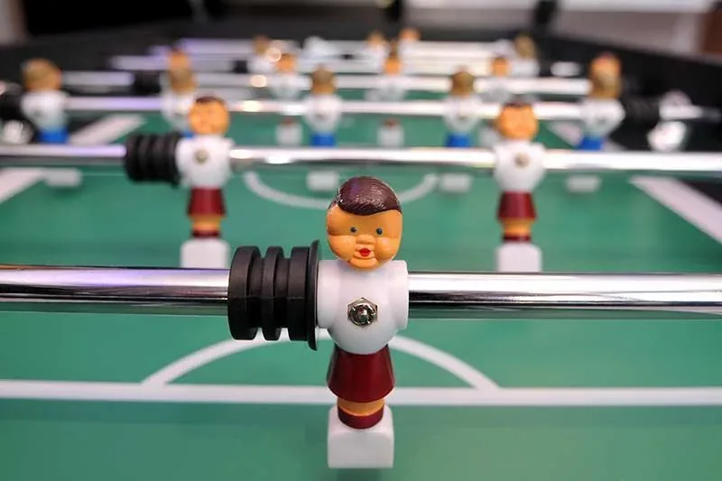 Close up of the red and white players on the foosball table