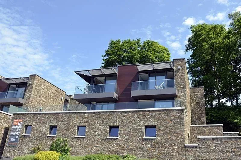 The houses seen from the lane below, stone and timber against the sky