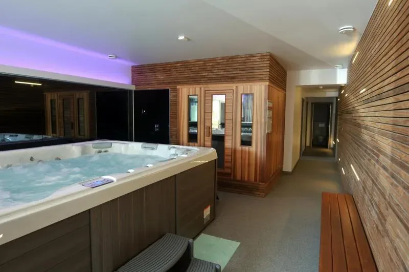 The indoor spa beside the infrared cabin, lit in violet